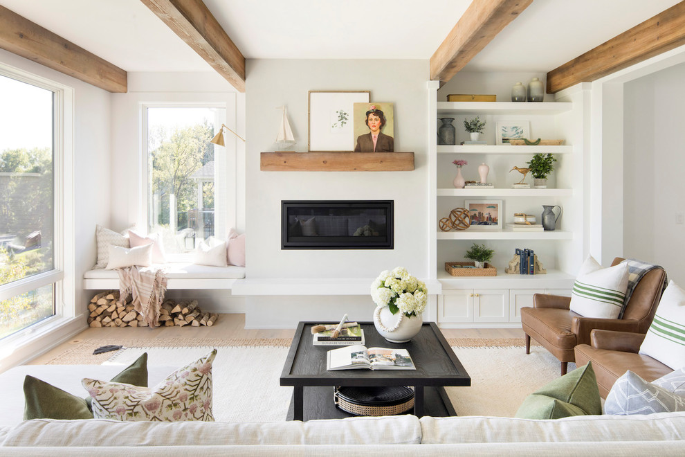 Inspiration for a country formal living room in Minneapolis with white walls, light hardwood floors, a ribbon fireplace, a metal fireplace surround and no tv.