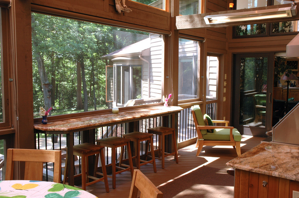 Large country backyard verandah in Cincinnati with an outdoor kitchen and a roof extension.