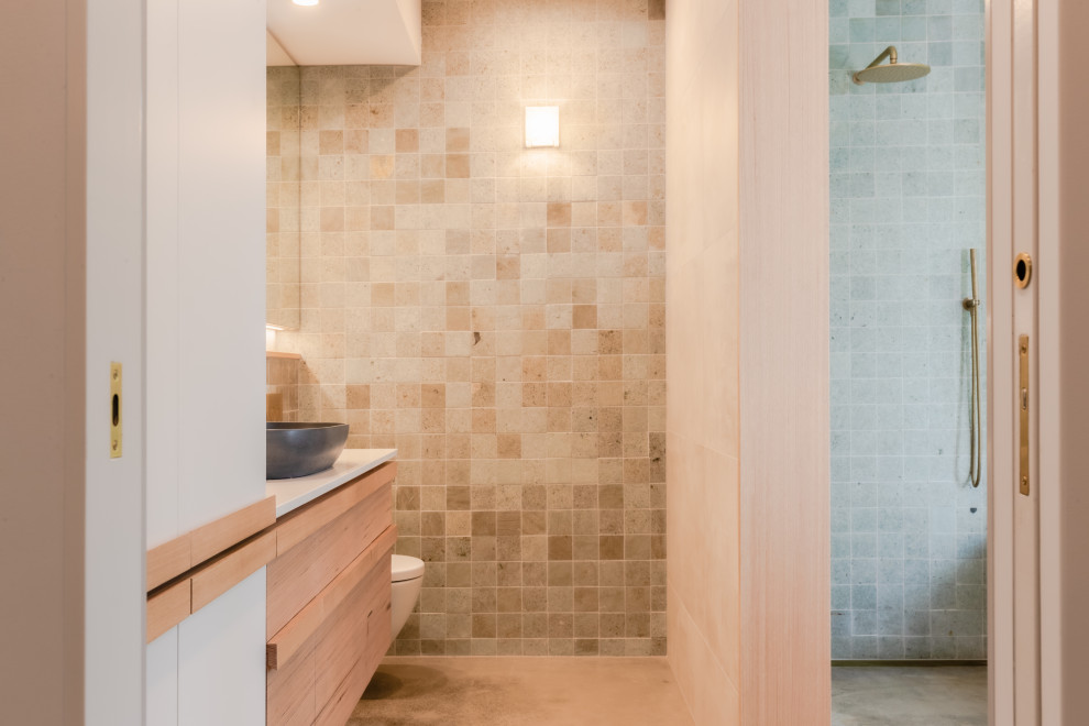 Large kids bathroom in Sunshine Coast with white cabinets, a one-piece toilet, green tile, multi-coloured walls, a trough sink, laminate benchtops, an open shower, white benchtops, a single vanity and a floating vanity.