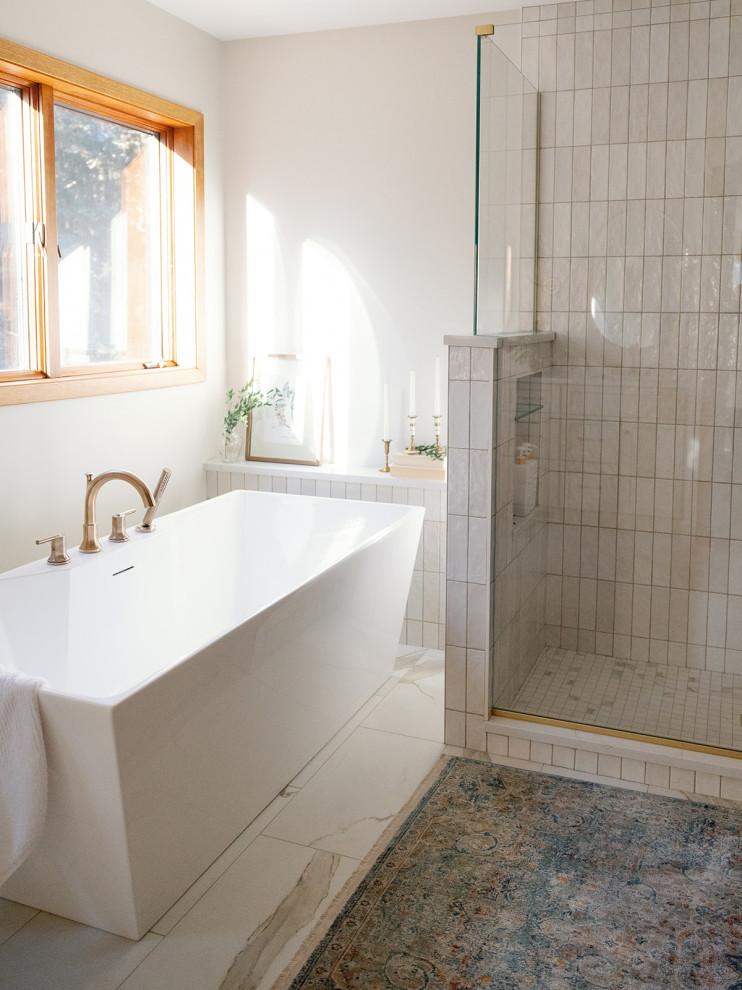 Freestanding bathtub - large transitional master white tile and porcelain tile porcelain tile, white floor and double-sink freestanding bathtub idea with shaker cabinets, white cabinets, white walls, an undermount sink, quartz countertops, a hinged shower door, white countertops, a niche and a built-in vanity