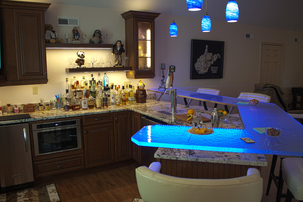 Design ideas for a large transitional l-shaped seated home bar in Huntington with an undermount sink, glass-front cabinets, dark wood cabinets, glass benchtops, medium hardwood floors, brown floor and blue benchtop.