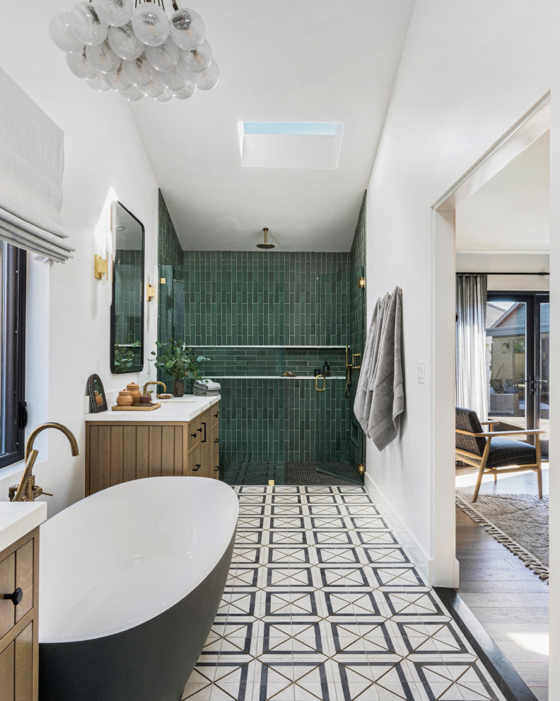 Contemporary bathroom in San Francisco with flat-panel cabinets, medium wood cabinets, a freestanding tub, a curbless shower, green tile, white walls, an undermount sink, multi-coloured floor, white benchtops, a double vanity and a built-in vanity.