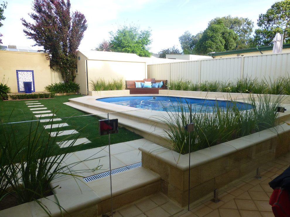 Inspiration for a mid-sized modern backyard round pool in Adelaide with natural stone pavers.
