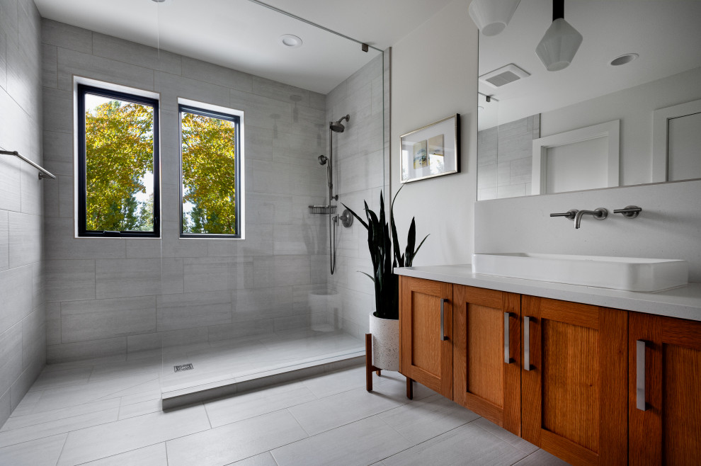 Inspiration for a medium sized contemporary shower room bathroom in Seattle with shaker cabinets, medium wood cabinets, an alcove shower, white tiles, porcelain tiles, white walls, porcelain flooring, a vessel sink, engineered stone worktops, white floors, an open shower, white worktops, a single sink and a floating vanity unit.