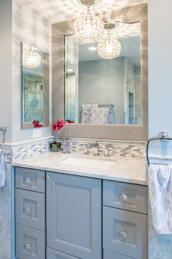 Mid-sized transitional bathroom in New York with recessed-panel cabinets, an undermount tub, a shower/bathtub combo, a two-piece toilet, blue tile, porcelain tile, blue walls, an undermount sink, engineered quartz benchtops, grey floor and an open shower.