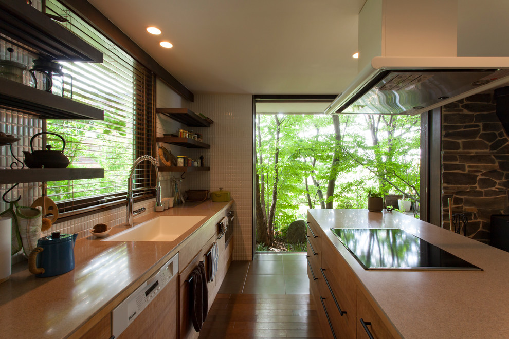 Inspiration for a midcentury galley open plan kitchen in Other with a single-bowl sink, medium hardwood floors, brown floor and brown benchtop.
