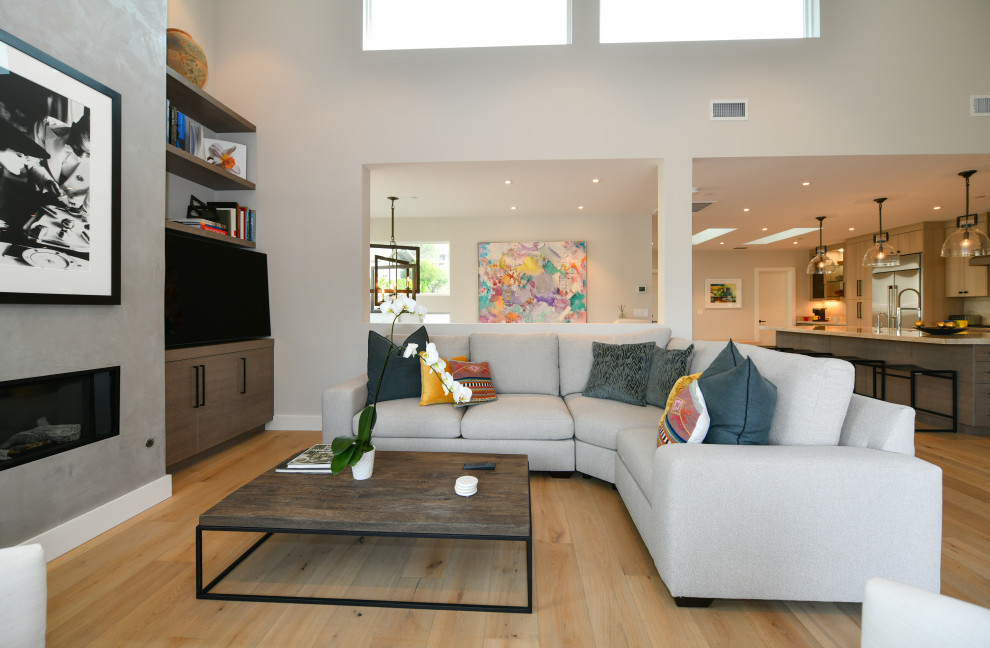 Inspiration for a huge transitional galley light wood floor and beige floor open concept kitchen remodel in San Francisco with a drop-in sink, flat-panel cabinets, gray cabinets, quartzite countertops, white backsplash, marble backsplash, stainless steel appliances, an island and white countertops