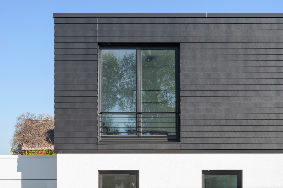 Contemporary black house exterior with concrete fiberboard siding.