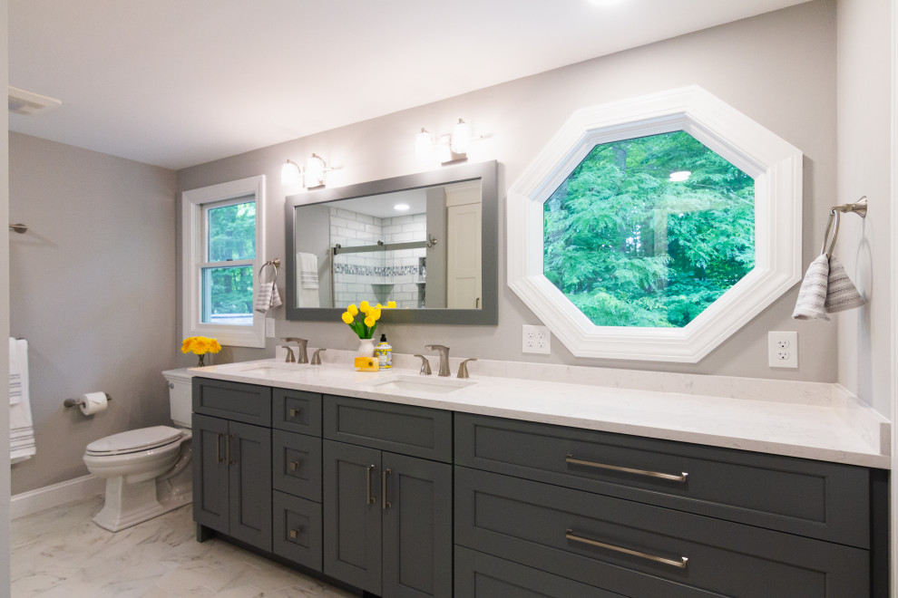 Mid-sized transitional master green tile and ceramic tile porcelain tile, white floor and double-sink sliding shower door photo with shaker cabinets, gray cabinets, a two-piece toilet, an undermount sink, quartz countertops, white countertops, a niche and a built-in vanity