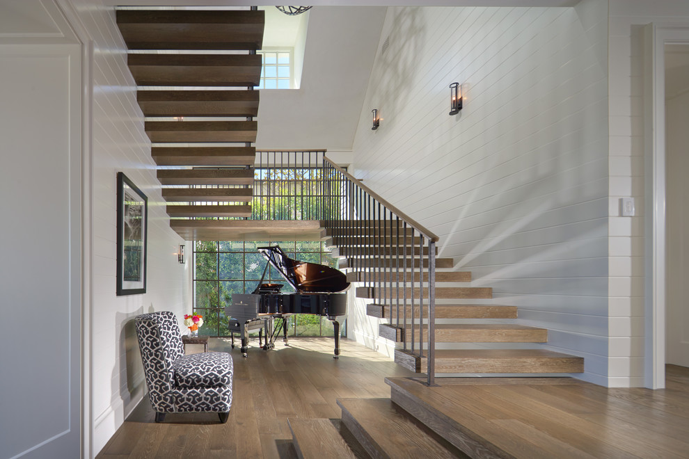 Beach style wood l-shaped staircase in Orange County with open risers.