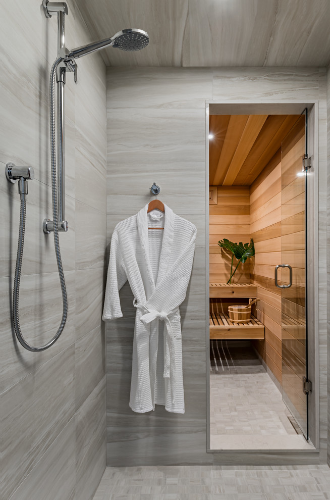 This is an example of a mid-sized transitional bathroom in Toronto with ceramic floors, grey floor, flat-panel cabinets, grey cabinets, a corner shower, a one-piece toilet, white tile, cement tile, grey walls, with a sauna, an undermount sink, engineered quartz benchtops and a hinged shower door.