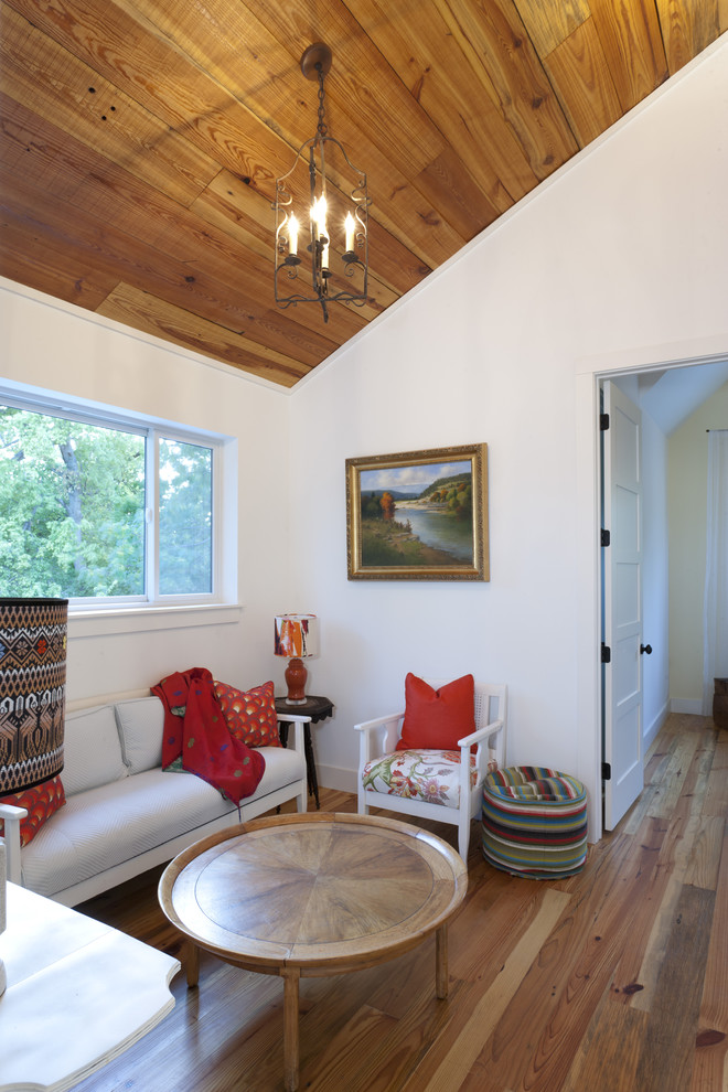 Inspiration for a country family room in Austin with white walls and medium hardwood floors.