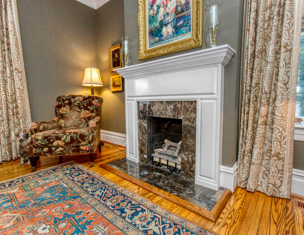 Photo of a small traditional enclosed living room in Richmond with a library, a standard fireplace and a stone fireplace surround.