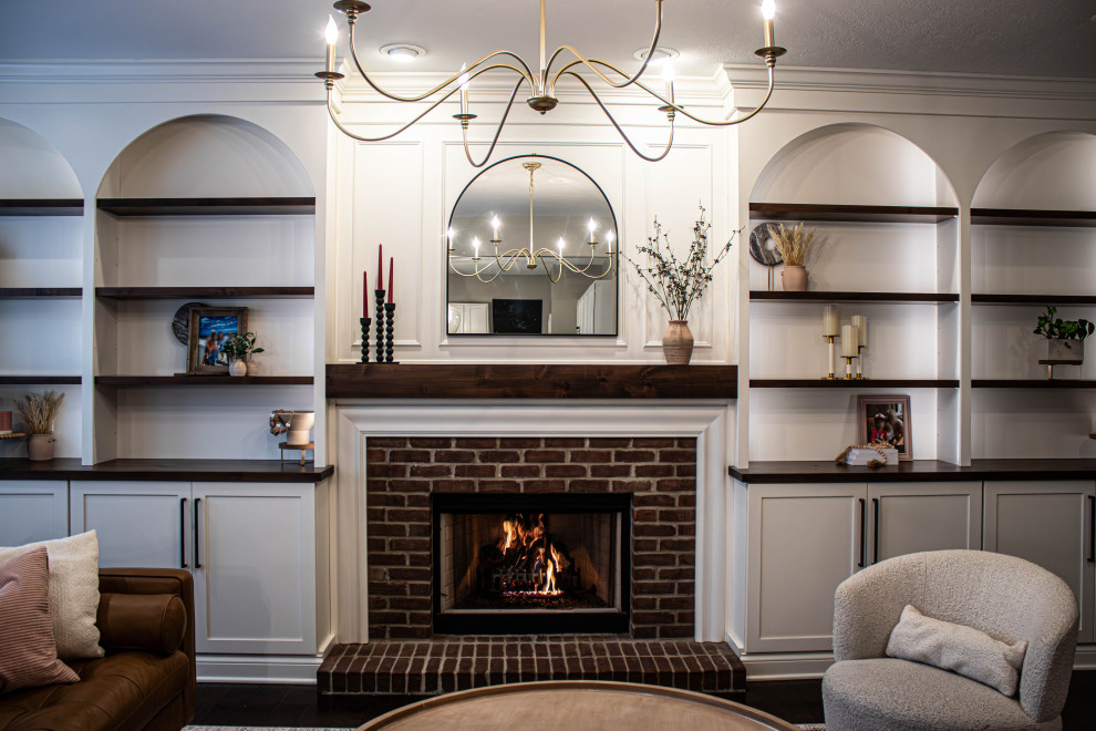 Inspiration for a mid-sized transitional open concept living room in Cleveland with grey walls, a standard fireplace, a brick fireplace surround, no tv and brown floor.