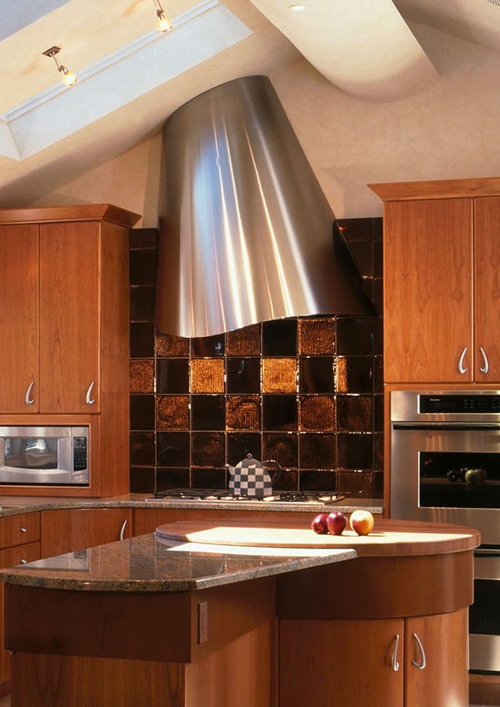 Photo of a contemporary kitchen in New York with flat-panel cabinets, brown cabinets, brown splashback, stainless steel appliances and with island.