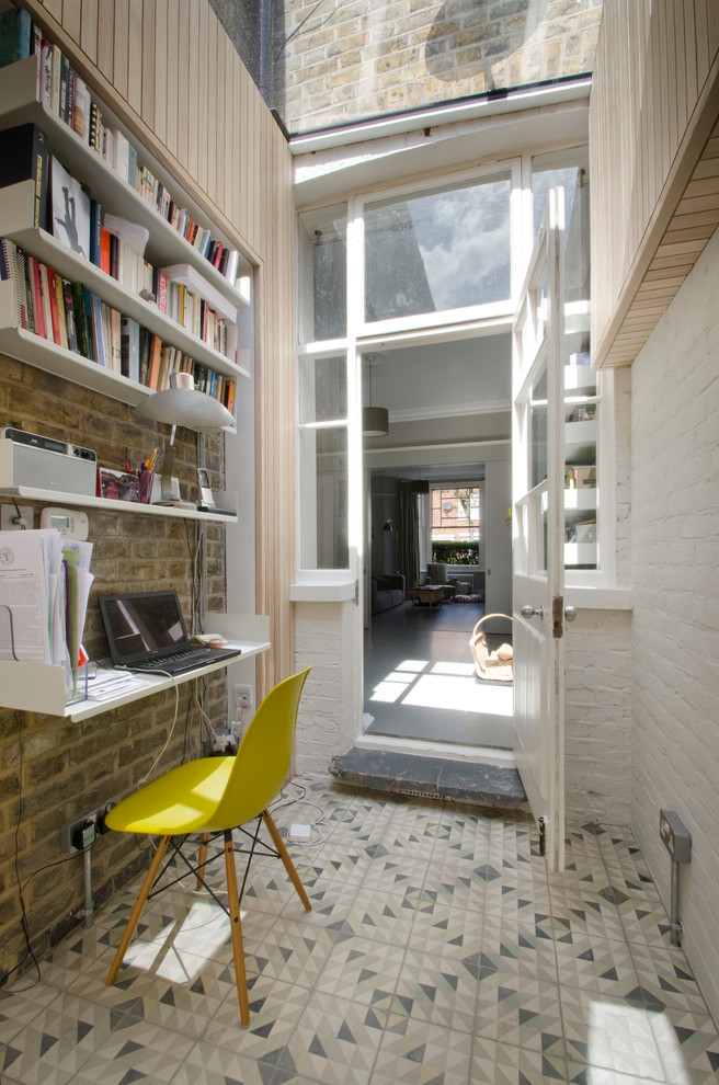 Small contemporary home office in London with white walls, no fireplace, a built-in desk and multi-coloured floor.