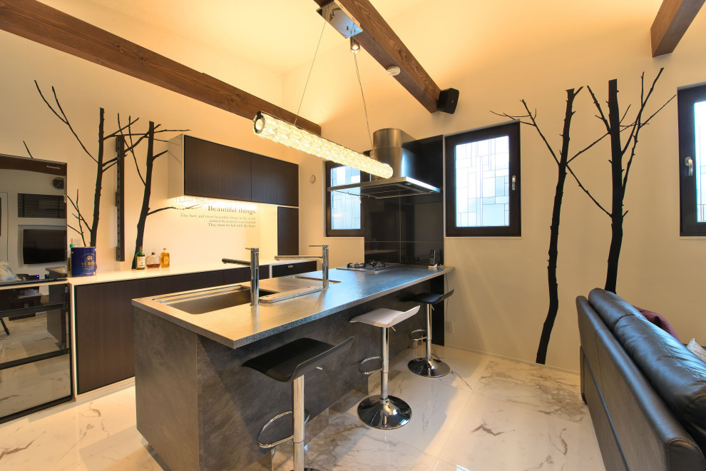 This is an example of a single-wall separate kitchen in Other with flat-panel cabinets, dark wood cabinets, stainless steel benchtops, grey splashback, with island, grey benchtop, an undermount sink, panelled appliances, marble floors, multi-coloured floor and exposed beam.