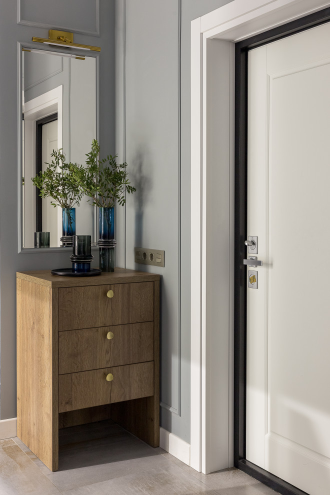 This is an example of a small contemporary foyer in Moscow with grey walls, ceramic flooring, a single front door, a white front door and grey floors.