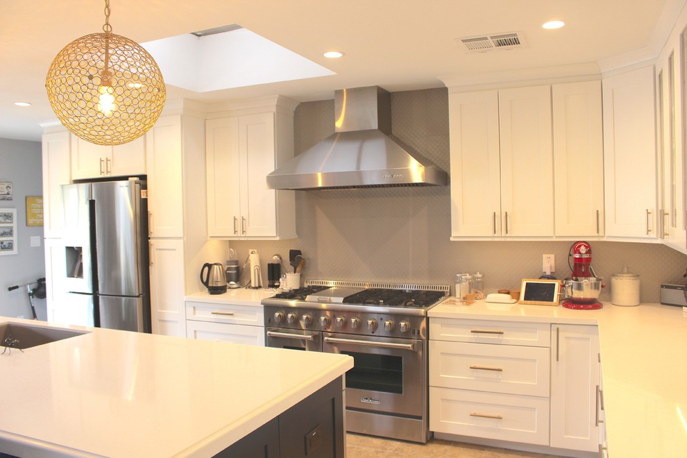 Inspiration for a large transitional l-shaped ceramic tile and beige floor open concept kitchen remodel in Phoenix with an undermount sink, shaker cabinets, white cabinets, quartzite countertops, gray backsplash, stainless steel appliances and an island