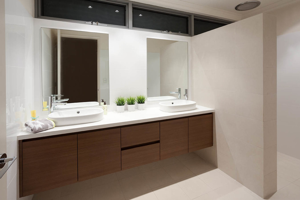 Large modern bathroom in Perth with flat-panel cabinets, medium wood cabinets, an alcove shower, beige tile, ceramic tile, beige walls, ceramic floors, a vessel sink, solid surface benchtops, beige floor, an open shower and white benchtops.