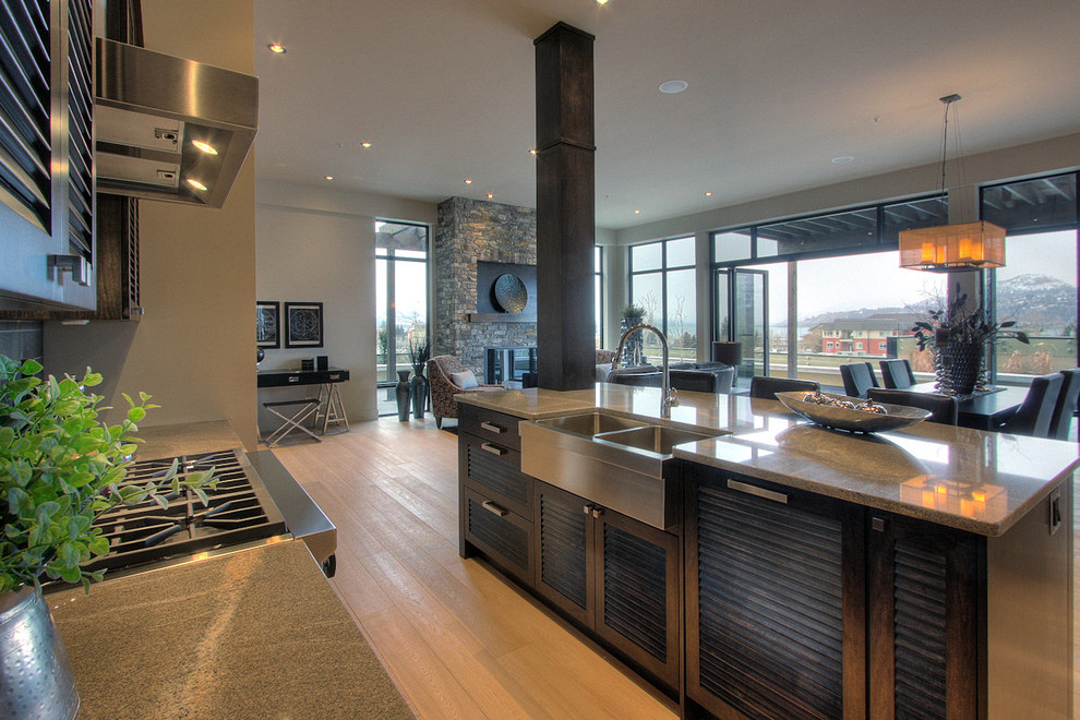 Contemporary kitchen in Vancouver with granite benchtops, louvered cabinets and dark wood cabinets.