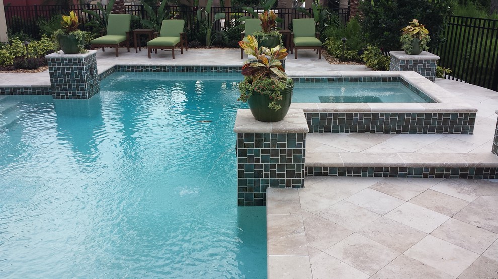 This is an example of a mid-sized mediterranean backyard custom-shaped lap pool in Other with natural stone pavers.