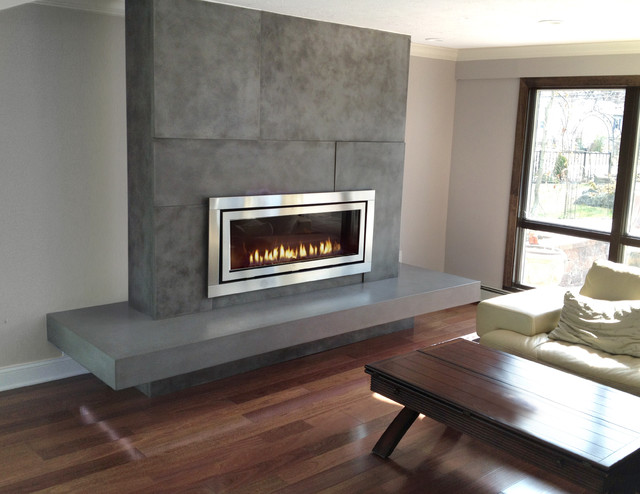 Concrete fireplace surround fabricated and installed by Trueform Concrete. The hearth was floating on an extended wooden sub frame and spanned over 10