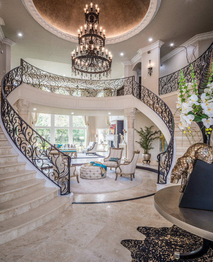Design ideas for a large traditional travertine u-shaped staircase in Houston with travertine risers and metal railing.