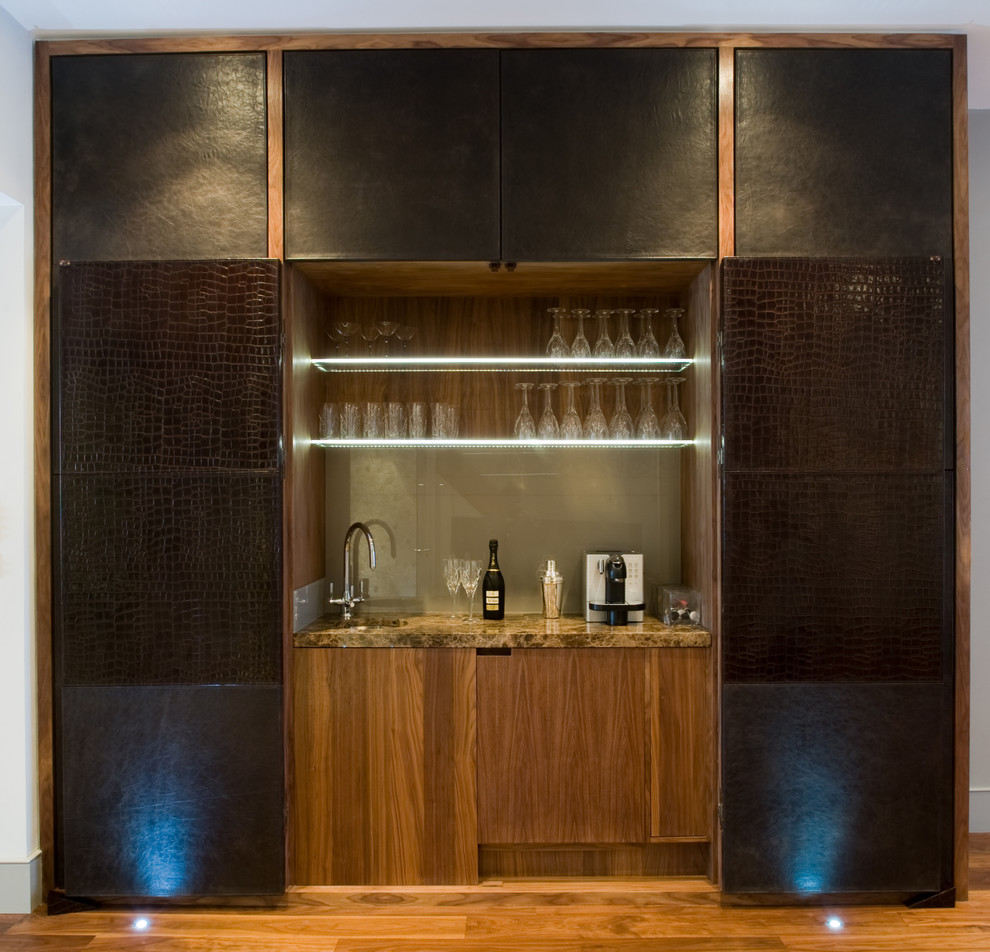 Inspiration for a large contemporary home bar in London with dark hardwood floors.