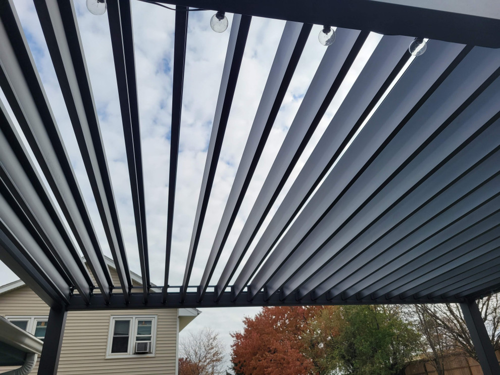 Inspiration for a large backyard ground level metal railing deck remodel with a pergola