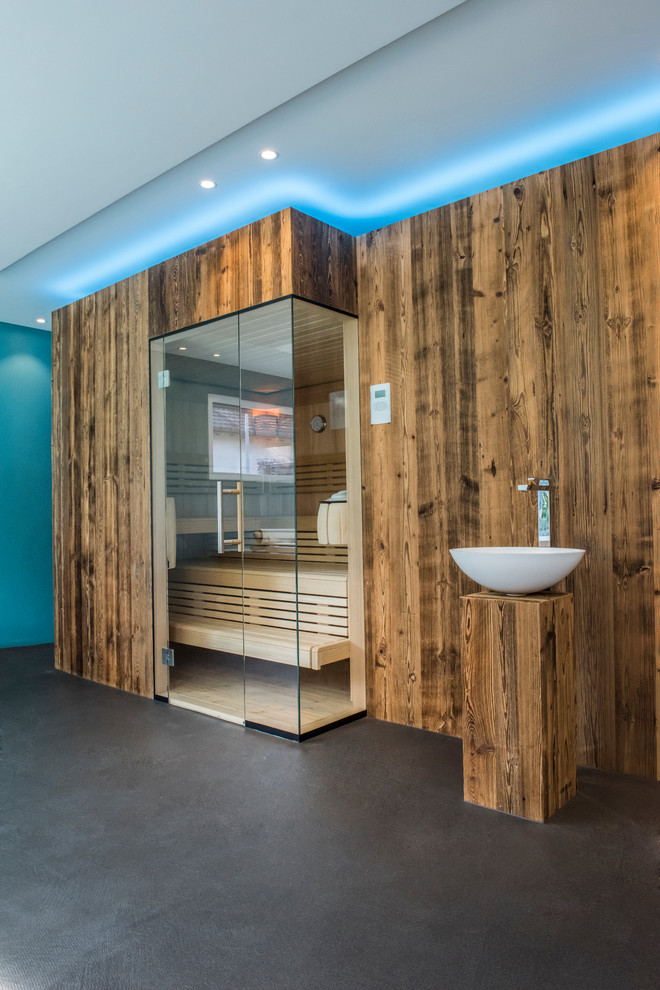 Photo of a contemporary bathroom in Other with blue walls, a vessel sink, wood benchtops and with a sauna.