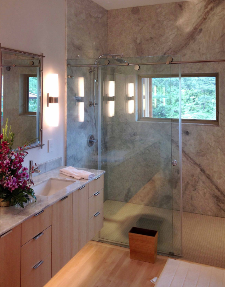 Design ideas for a large asian master bathroom in Hawaii with flat-panel cabinets, light wood cabinets, a double shower, gray tile, marble, beige walls, bamboo floors, a drop-in sink, granite benchtops, beige floor, a sliding shower screen and beige benchtops.