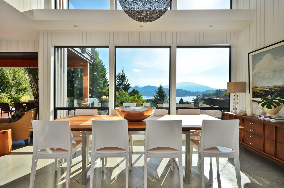 Design ideas for a modern dining room in Vancouver with concrete floors.