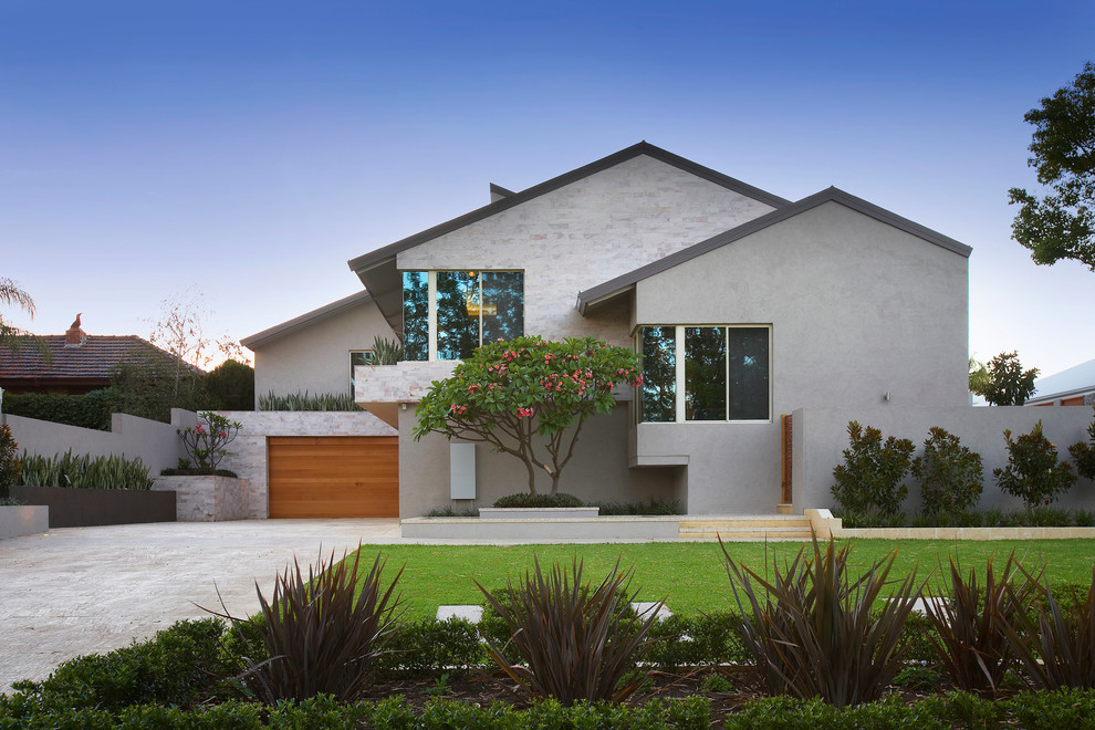 Design ideas for a large tropical split-level beige exterior in Perth with stone veneer.