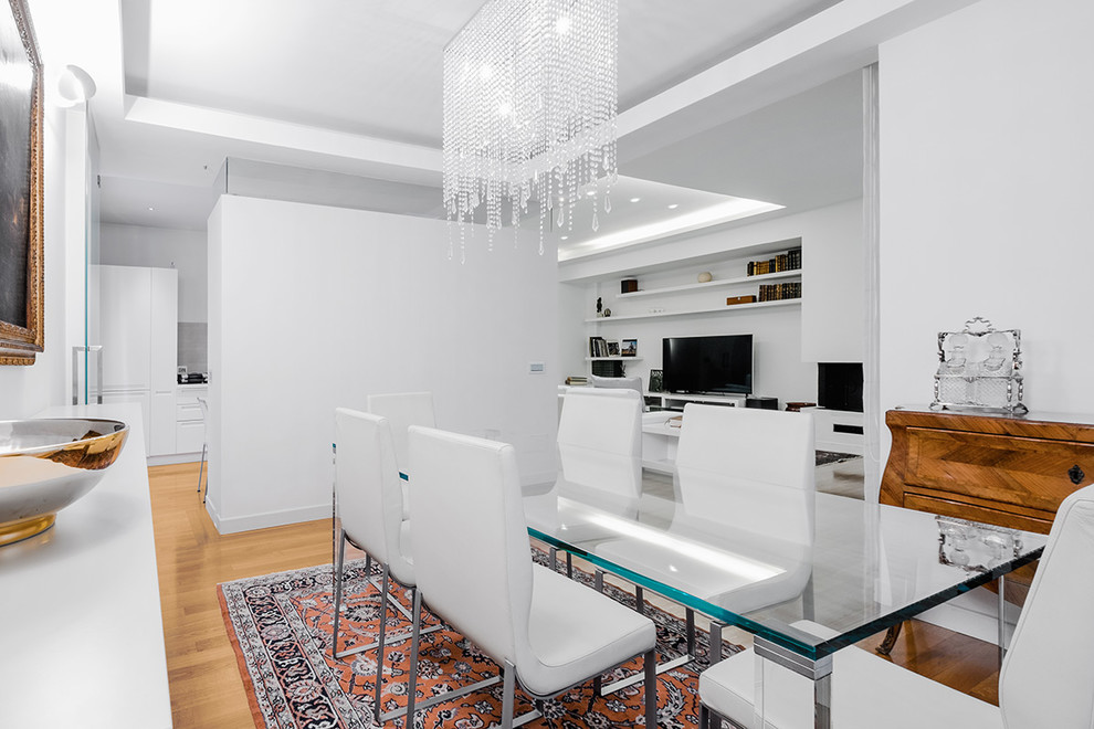 This is an example of a mid-sized contemporary open plan dining in Rome with white walls, light hardwood floors, a corner fireplace, a plaster fireplace surround and beige floor.