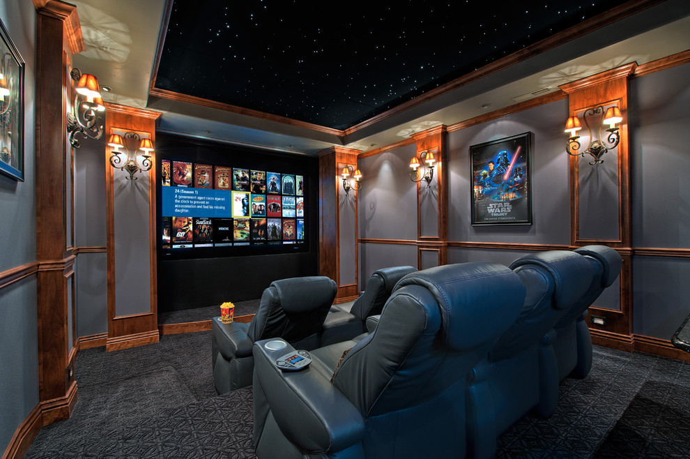 This is an example of a traditional enclosed home theatre in Sacramento with blue walls and a projector screen.