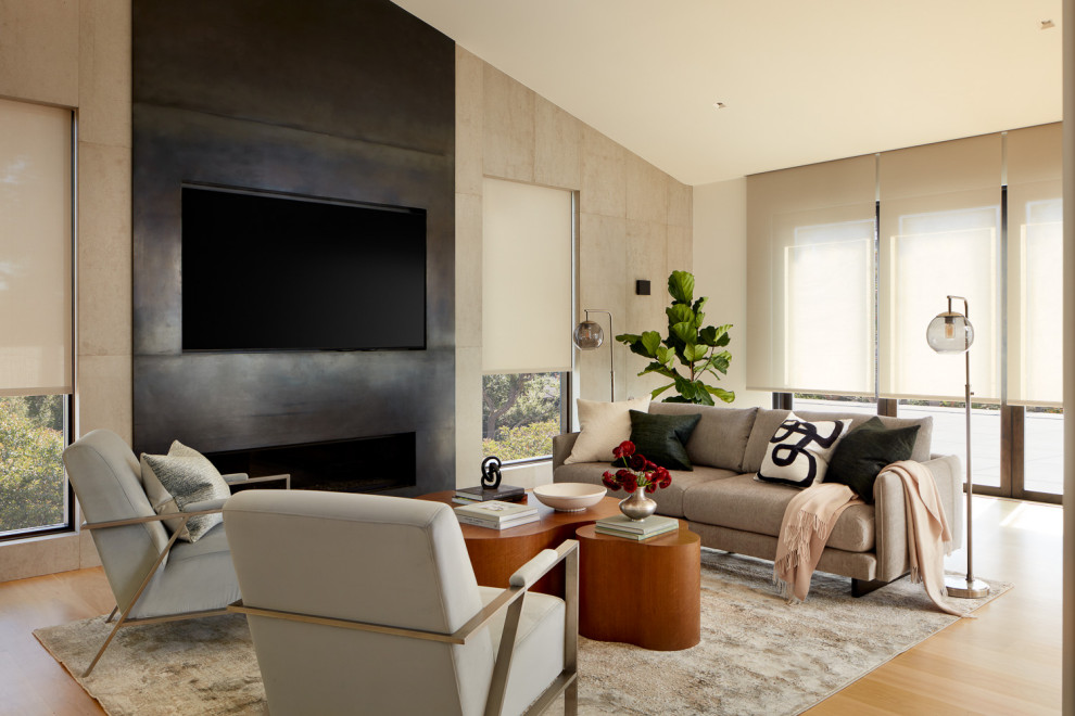 This is an example of a large modern open concept living room in San Francisco with a metal fireplace surround and a wall-mounted tv.