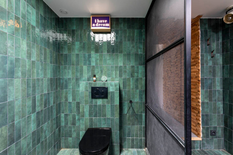 Photo of a mid-sized master bathroom in Paris with open cabinets, black cabinets, a curbless shower, a wall-mount toilet, green tile, ceramic tile, green walls, ceramic floors, a pedestal sink, zinc benchtops, turquoise floor, an open shower, black benchtops, a single vanity, a freestanding vanity and decorative wall panelling.
