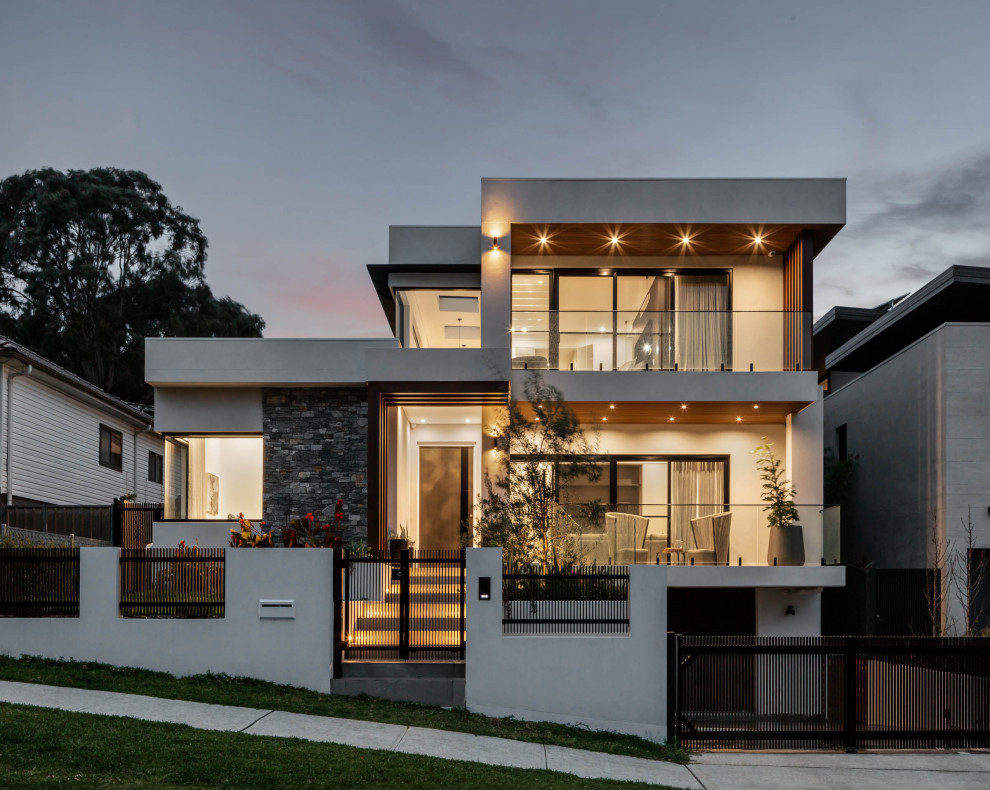 Photo of a contemporary white house exterior in Sydney with a flat roof.