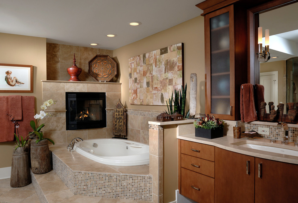 This is an example of a large contemporary master bathroom in Chicago with an undermount sink, flat-panel cabinets, medium wood cabinets, beige tile, a drop-in tub, beige walls, ceramic floors, beige floor, a corner shower, mosaic tile, granite benchtops and a hinged shower door.