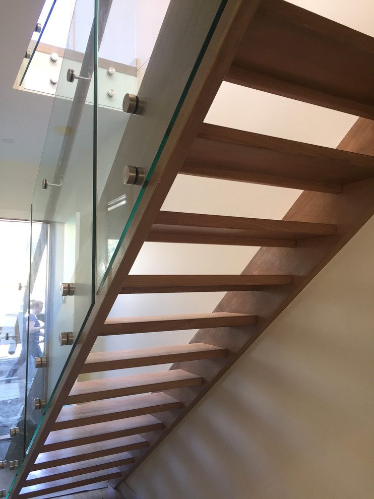 Small wood straight staircase in Melbourne with glass railing.