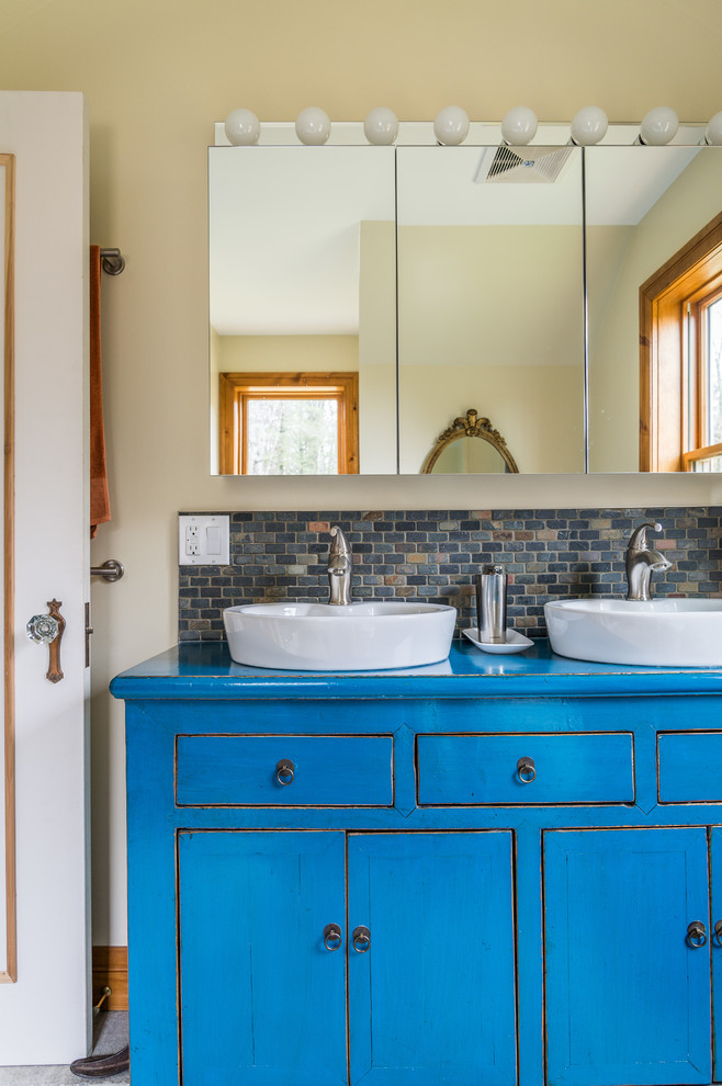 Country bathroom in Toronto with blue cabinets.