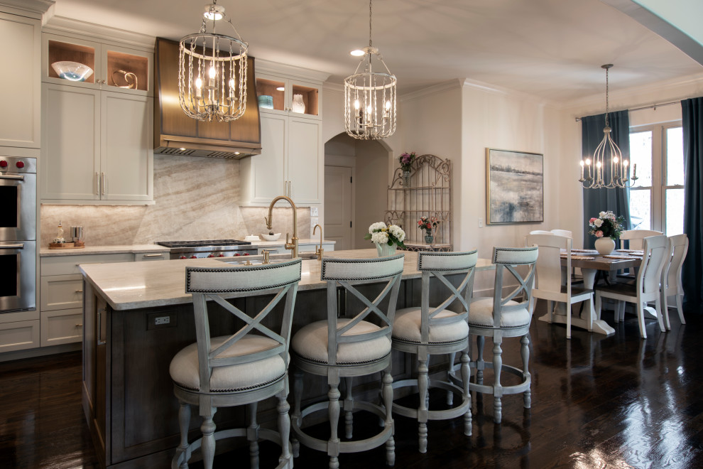 Large transitional l-shaped dark wood floor and brown floor open concept kitchen photo in Nashville with an undermount sink, beaded inset cabinets, white cabinets, quartzite countertops, beige backsplash, stone slab backsplash, stainless steel appliances, an island and beige countertops