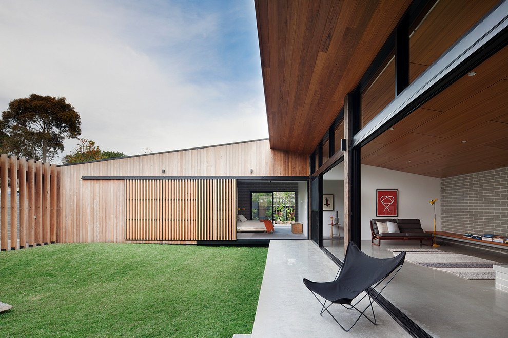 Design ideas for a contemporary one-storey exterior in Melbourne with wood siding.