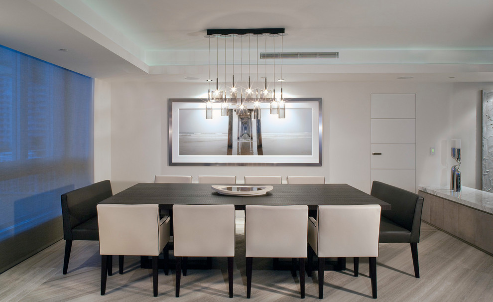 Inspiration for a contemporary dining room in Miami with white walls and beige floor.