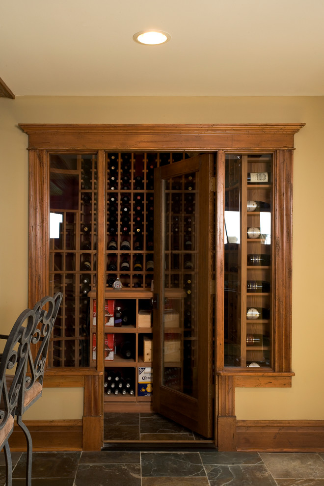 Inspiration for a large traditional wine cellar in Milwaukee with slate floors and display racks.