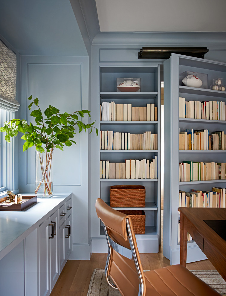 This is an example of a transitional home office in Houston with blue walls.