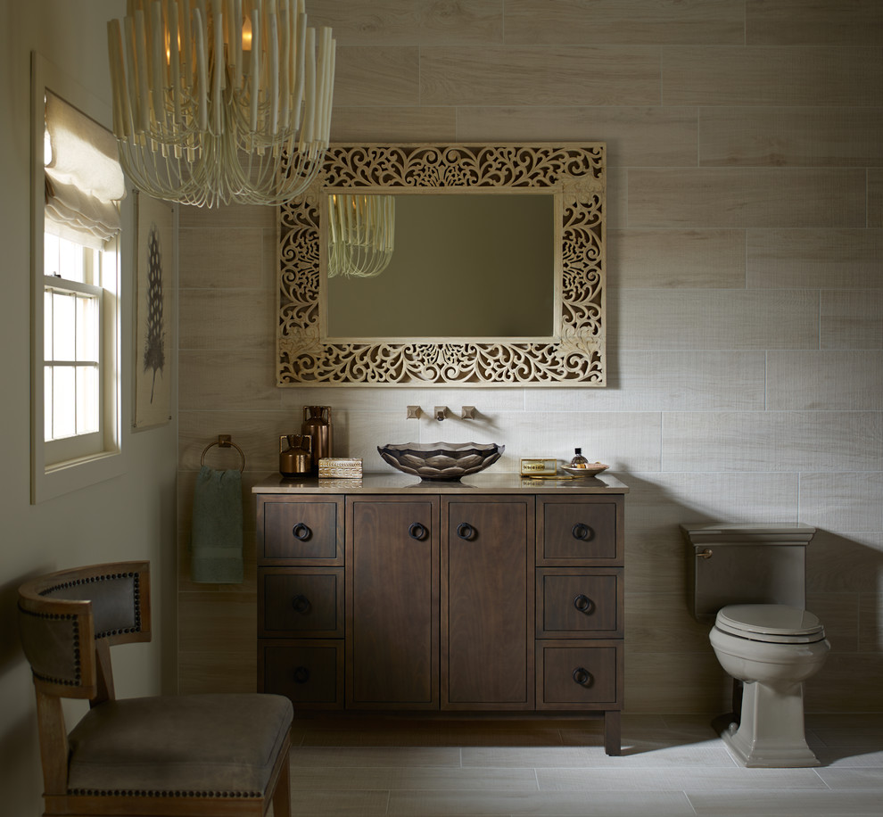 Design ideas for a mid-sized country 3/4 bathroom in Albuquerque with flat-panel cabinets, brown cabinets, a two-piece toilet, beige tile, porcelain tile, beige walls, light hardwood floors, a vessel sink, solid surface benchtops and beige floor.