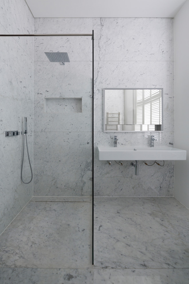 Photo of a mid-sized traditional master bathroom in London with recessed-panel cabinets, a freestanding tub, an open shower, white tile, marble, white walls, marble floors, a wall-mount sink, marble benchtops, white floor and an open shower.