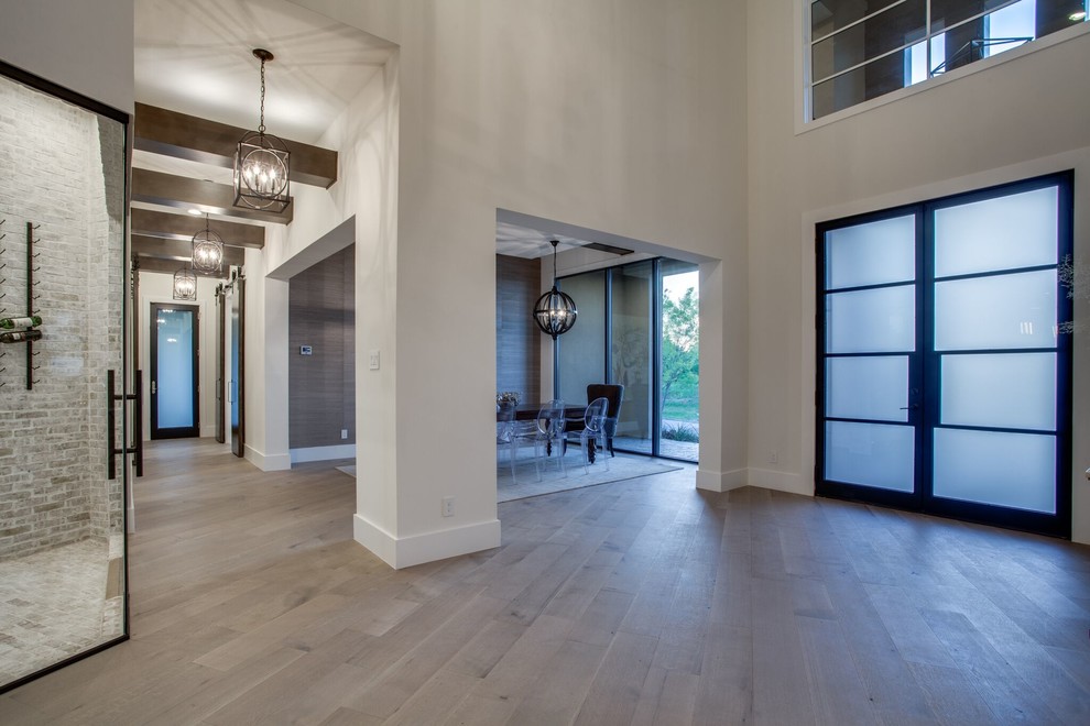 Inspiration for a large transitional foyer in Dallas with beige walls, medium hardwood floors, a double front door, a glass front door and brown floor.